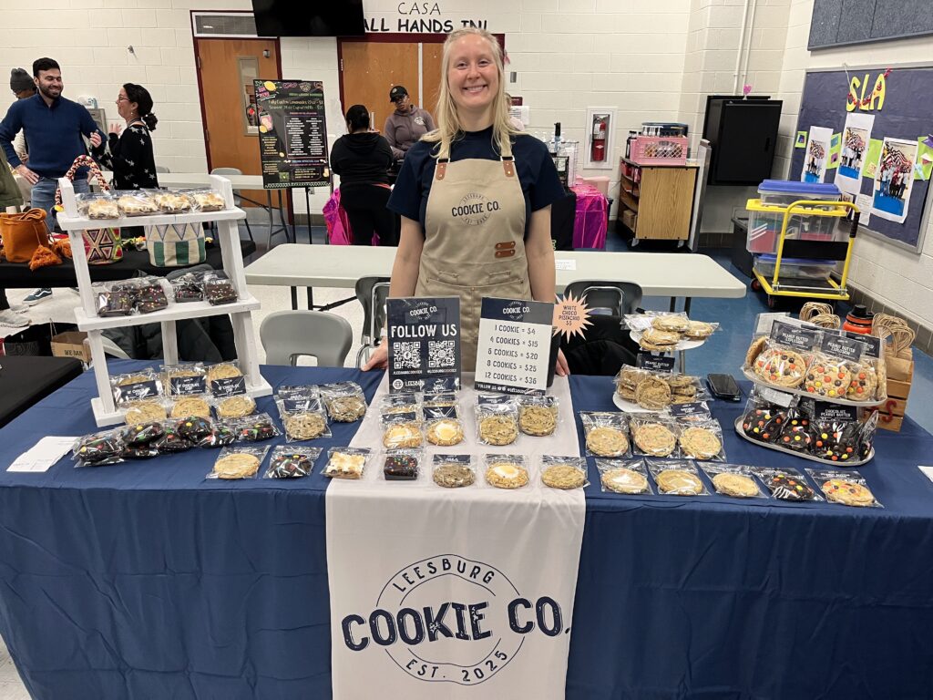 Christal standing behind a Leesburg Cookie Co table diplay